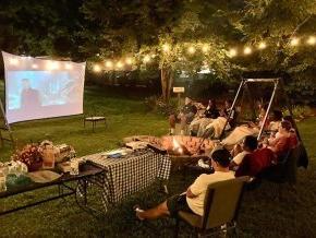 International students enjoying a cookout and movie under the stars.